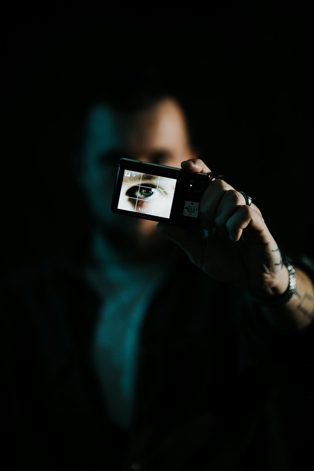 Portrait of a Dutch film director in a dark turtleneck standing near a film camera